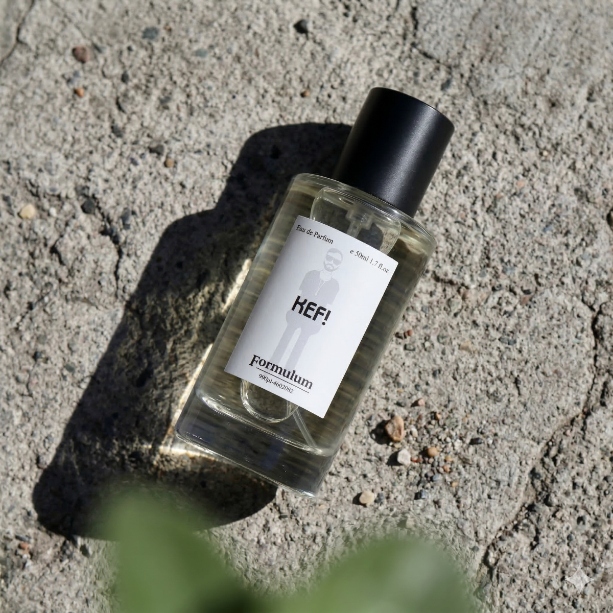 Perfume bottle labeled 'KEF!' by 'formulam' on a concrete surface